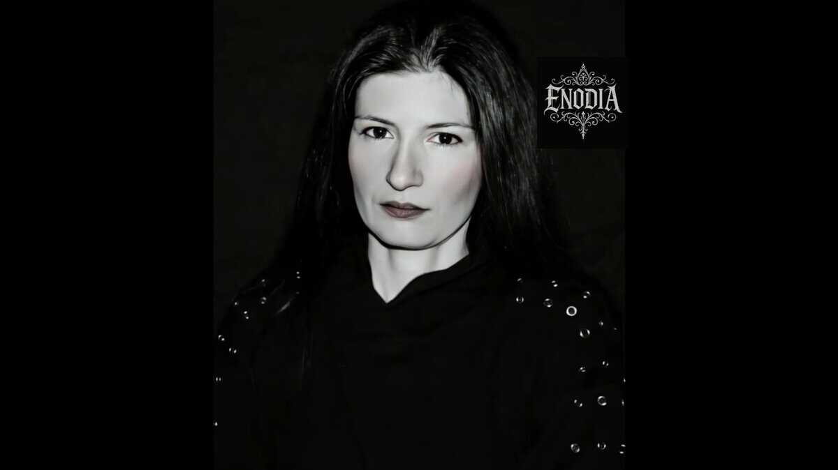 Black-and-white portrait of a woman with dark hair and a black outfit, ENDIA logo visible on the right side.