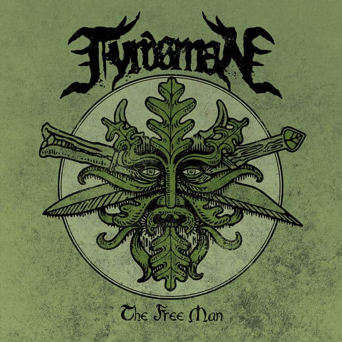 Album cover with a green textured background, featuring a circular emblem containing a leaf-headed, winged creature and the text 'The Free Man' at the bottom. The band name appears in a black, ornate font above the circle.