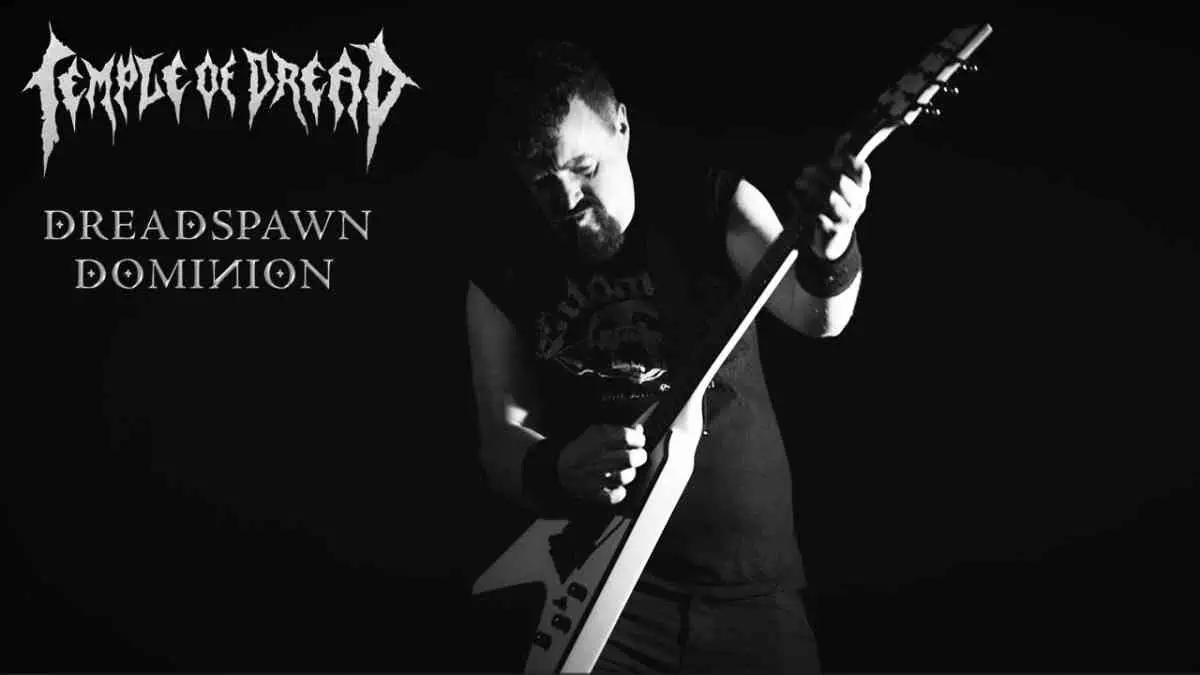 Black-and-white promo image of a guitarist playing a V-shaped guitar, with the band logo and the text “Dreadspawn Dominion” on the left.