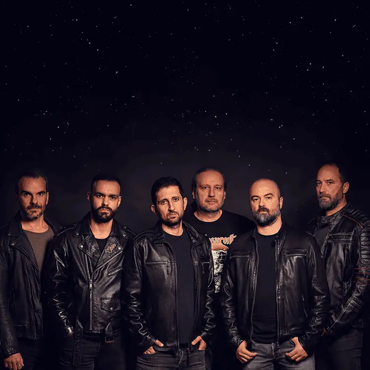 Six men in black leather jackets pose together against a dark starry background, forming a band portrait.