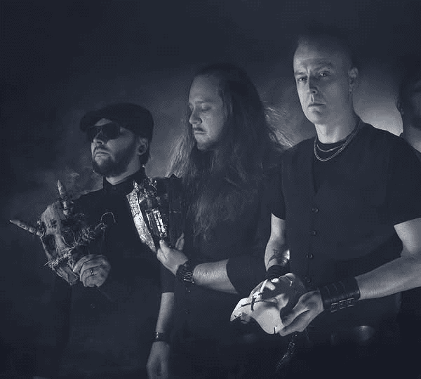 Five men in black attire stand in a smoky, moody studio; the central figure holds a pale mask.
