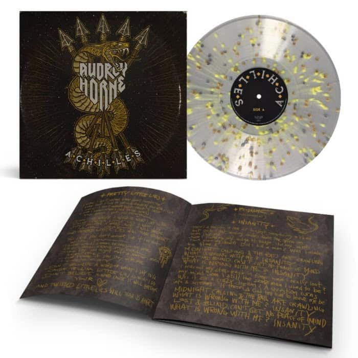 Audrey Horne Achilles album art with an ornate logo, a clear gold-splatter vinyl, and a handwritten lyric booklet laid open.
