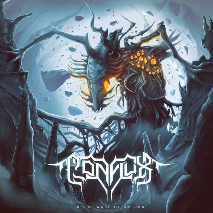 Ice-blue cavern with a horned dragon creature and glowing orange eyes; the album title 'In the Wake of Saturn' is at the bottom.